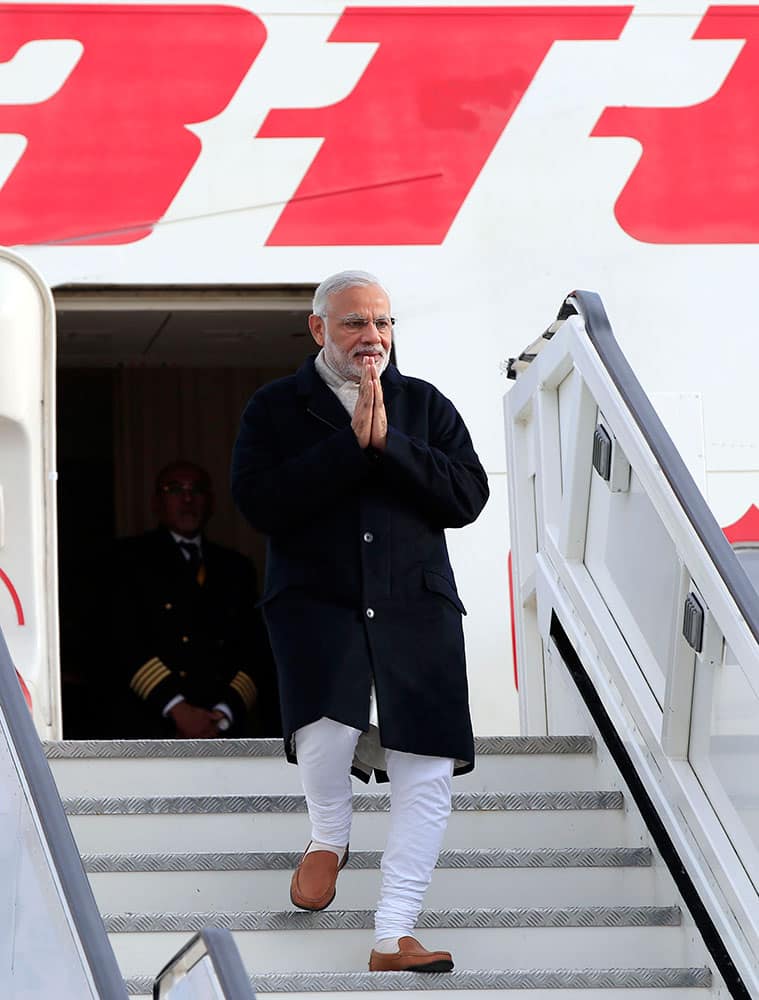 Indian Prime Minister Narendra Modi gestures as he arrives at Heathrow Airport, London, for an official three day visit.