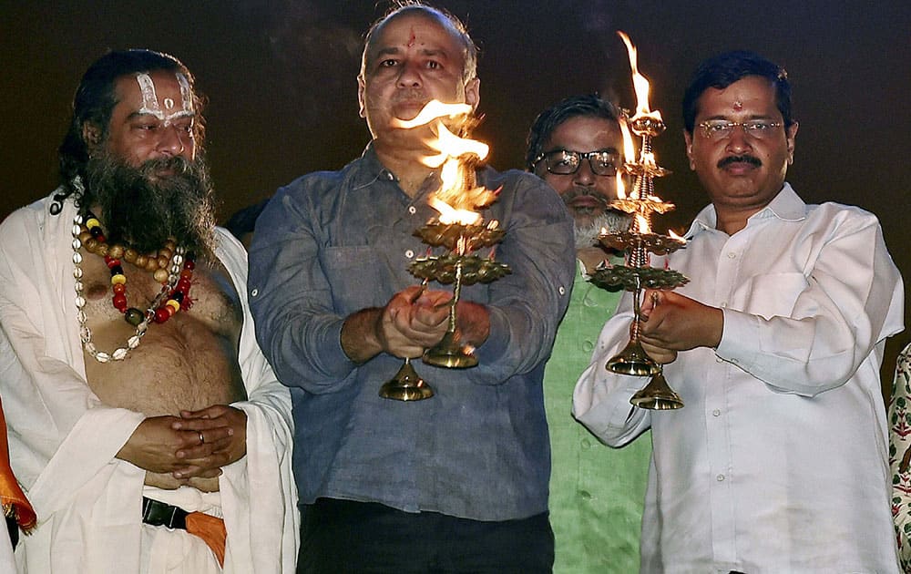 Delhi Chief Minister Arvind Kejriwal along with his deputy Manish Sisodia performing aarti of Yamuna River as part of the goverments efforts towards cleaning the river and promoting tourism, in New Delhi.