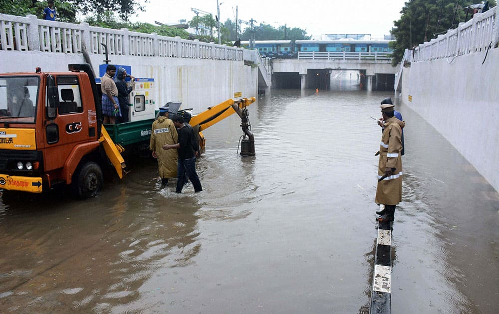 Corporation workers pumping out the rainwater from a waterlogged subway following heavy rains in Chennai.
