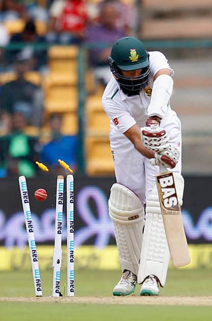 South Africa's captain Hashim Amla is bowled out by India's Varun Aaron during the first day of their second cricket test match in Bangalore.