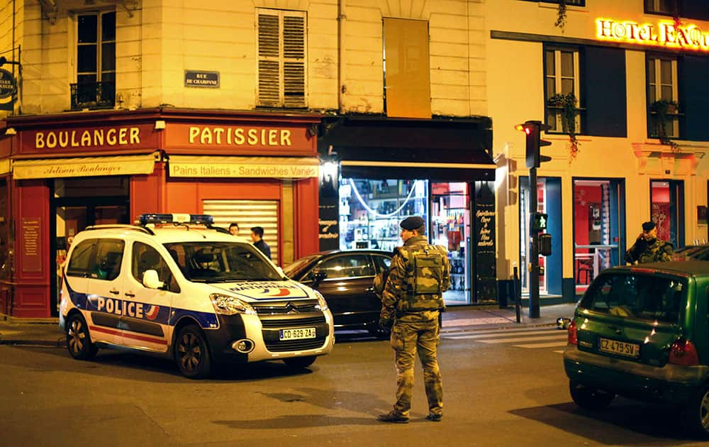 A French soldier stands in a street next to Rue de Charonne in Paris. A cafe on Rue de Charonne was one of the targeted sites in Friday's shootings. A series of attacks targeting young concert-goers, soccer fans and Parisians enjoying a Friday night out at popular nightspots killed over 100 people in the deadliest violence to strike France since World War II. 