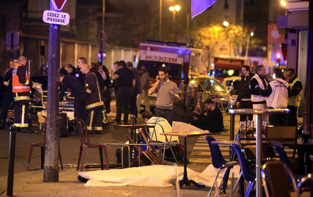 Victims lay on the pavement in a Paris restaurant. Well over 100 people were killed in Paris on Friday night in a series of shooting, explosions. French President Francois Hollande declared a state of emergency and announced that he was closing the country's borders.