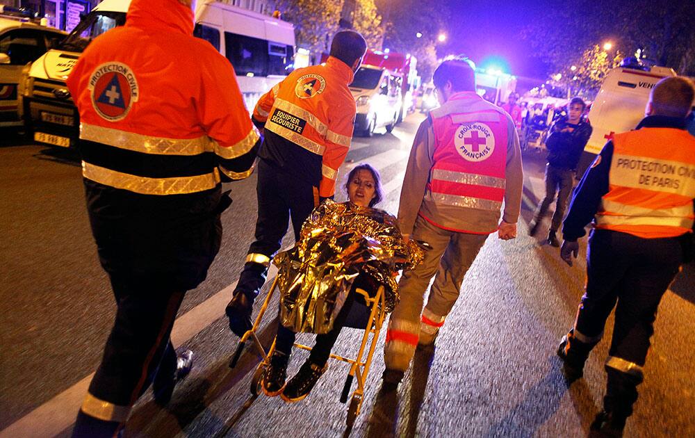 A person is being evacuated after a shooting, outside the Bataclan theater in Paris. A series of attacks targeting young concert-goers, soccer fans and Parisians enjoying a Friday night out at popular nightspots killed over 100 people in the deadliest violence to strike France since World War II.