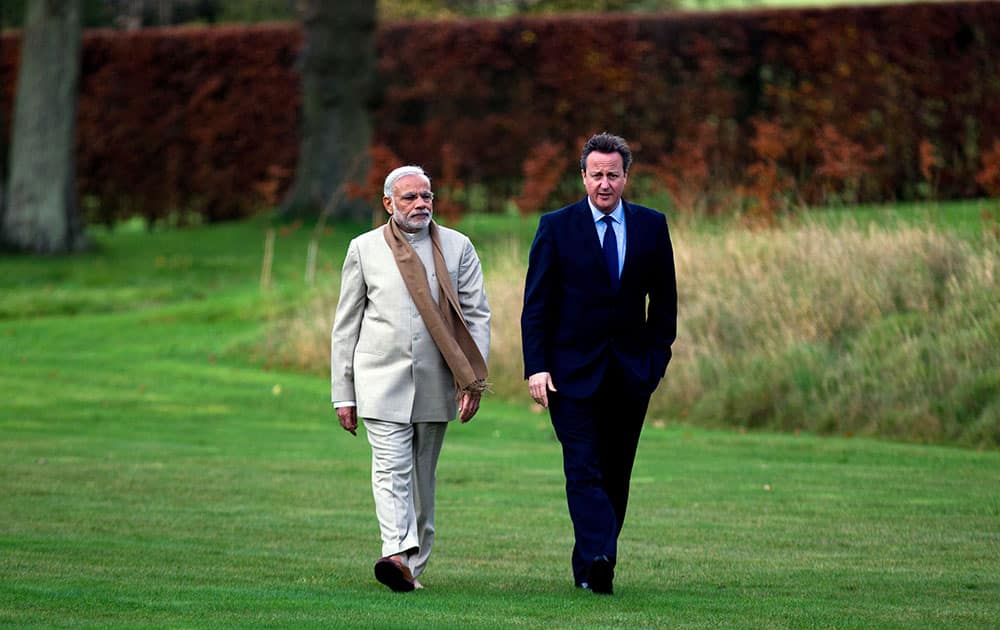 British Prime Minister David Cameron walks in the garden at his official country residence Chequers in Wendover, England, with his Indian counter-part Narendra Modi on the second day of his official visit to the UK.