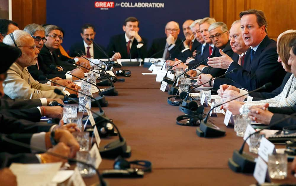 Indian Prime Minister Narendra Modi listens as Prime Minister David Cameron talks, during the CEO Forum inside 10 Downing Street in London, on the second day of his visit to the UK.