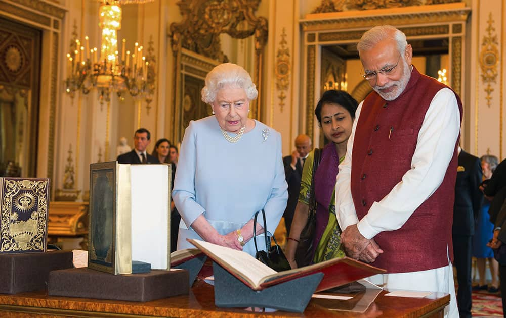 Britain's Queen Elizabeth II and Indian Prime Minister Narendra Modi view items of interest, put on display from the Royal Collection, at Buckingham Palace in London, on the second day of his visit to the UK.