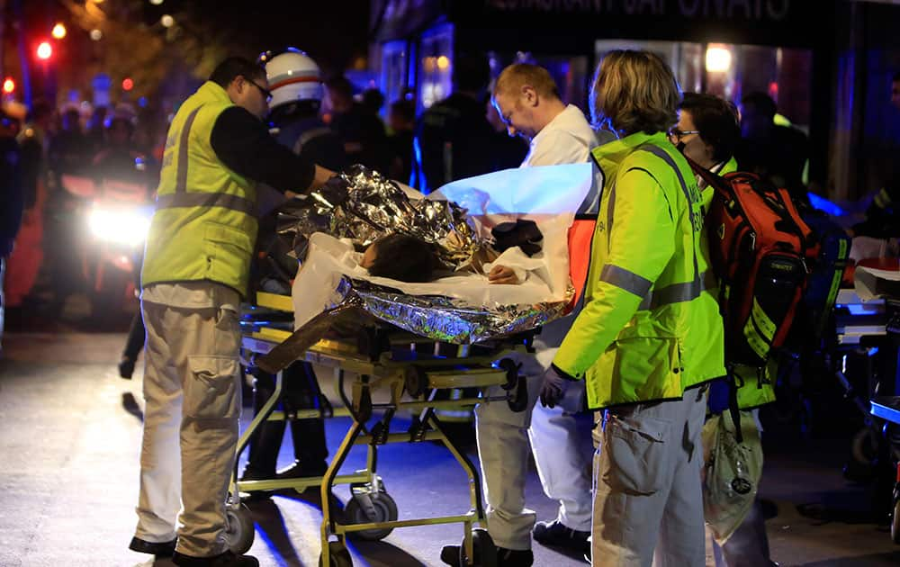 A person is being evacuated from the Bataclan theater after a shooting in Paris.