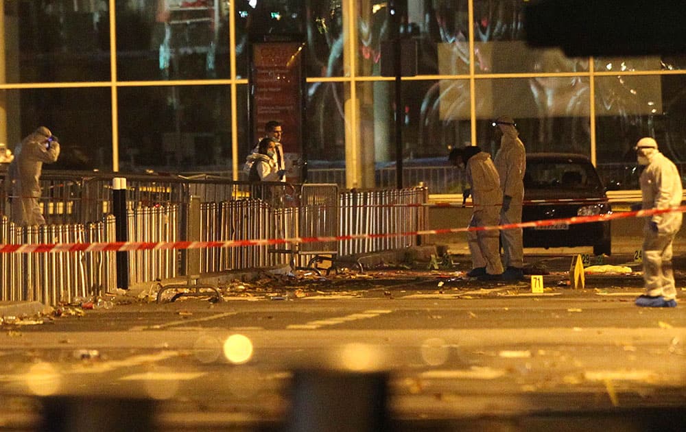 Investigating police officers work outside the Stade de France stadium after an explosion and after international friendly soccer match France against Germany, in Saint Denis, outside Paris.