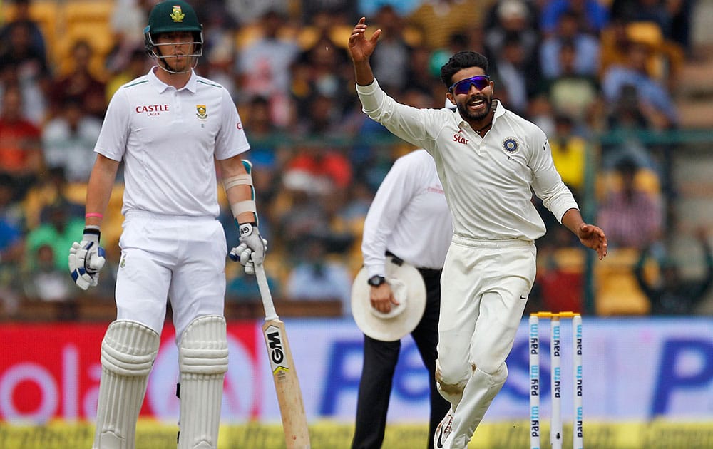 Ravindra Jadeja celebrates the dismissal of South Africa's AB de Villiers during the first day of their second cricket test match in Bangalore.