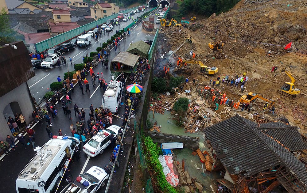 Rescuers search for victims following a landslide in Lishui in east China's Zhejiang province.