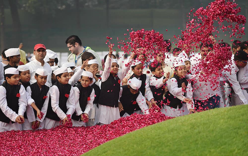 Children dressed as the first prime minister of India Jawaharlal Nehru pay floral tribute to him on his birth anniversary at Shanti Van in New Delhi.
