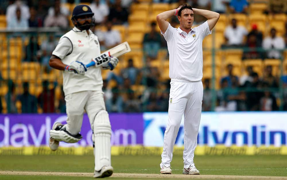 South Africa's Kyle Abbott reacts after India's Shikhar Dhawan hit a boundary on his delivery during the first day of their second cricket test match in Bangalore.