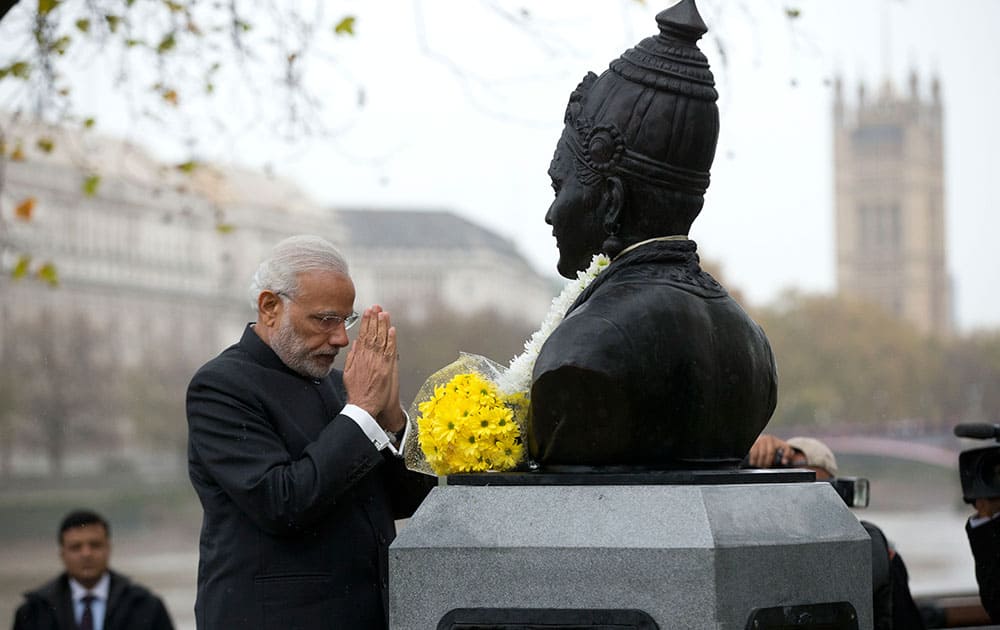 Indian Prime Minister Narendra Modi bows his head after unveiling a statue of 12th century Indian philosopher Basaveshwara, who was one of the pioneers of the idea of democracy, in London.