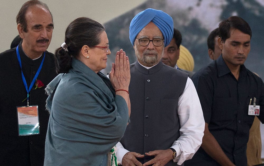 Congress party President Sonia Gandhi, walks past former Indian prime minister Manmohan Singh as she leaves after celebrations marking the birth anniversary of the first Indian Prime Minister Jawaharlal Nehru in New Delhi.