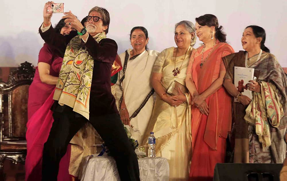 Bollywood superstar Amitabh Bachchan takes a selfie with Chief Minister of West Bengal state Mamata Banerjee, fourth right, his wife Jaya Bachchan, third right, and Bollywood actress Sharmila Tagore, second right, during the inauguration of the Kolkata International Film Festival.