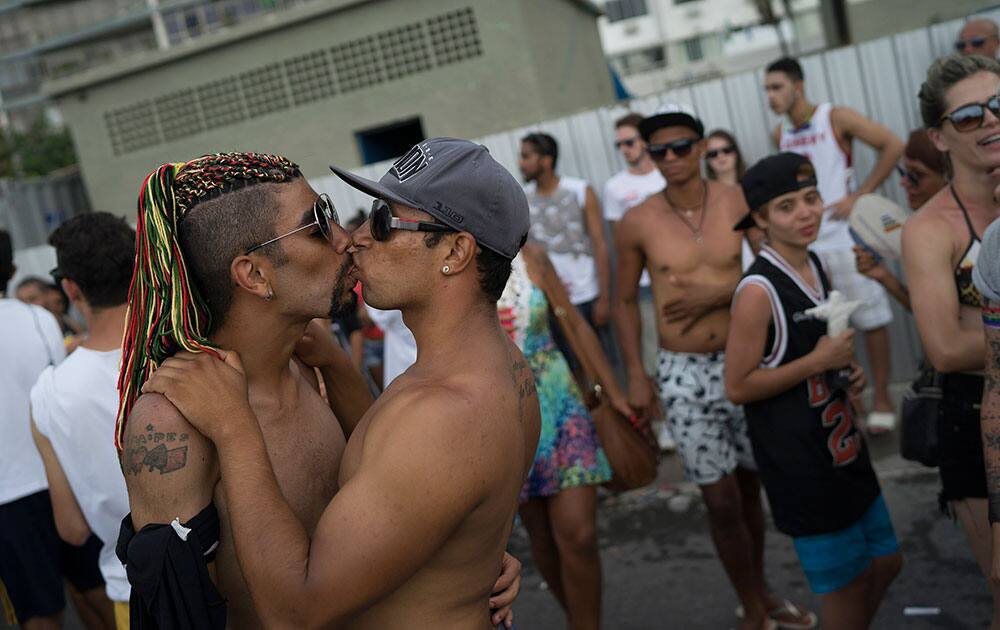 Two men kiss during the Gay Pride Parade at Copacabana beach, in Rio de Janeiro, Brazil.