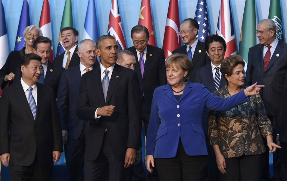 President Barack Obama walks with Germany’s Chancellor Angela Merkel and other leaders as they try to figure out which way to go following the G20 Summit group photo in Antalya.