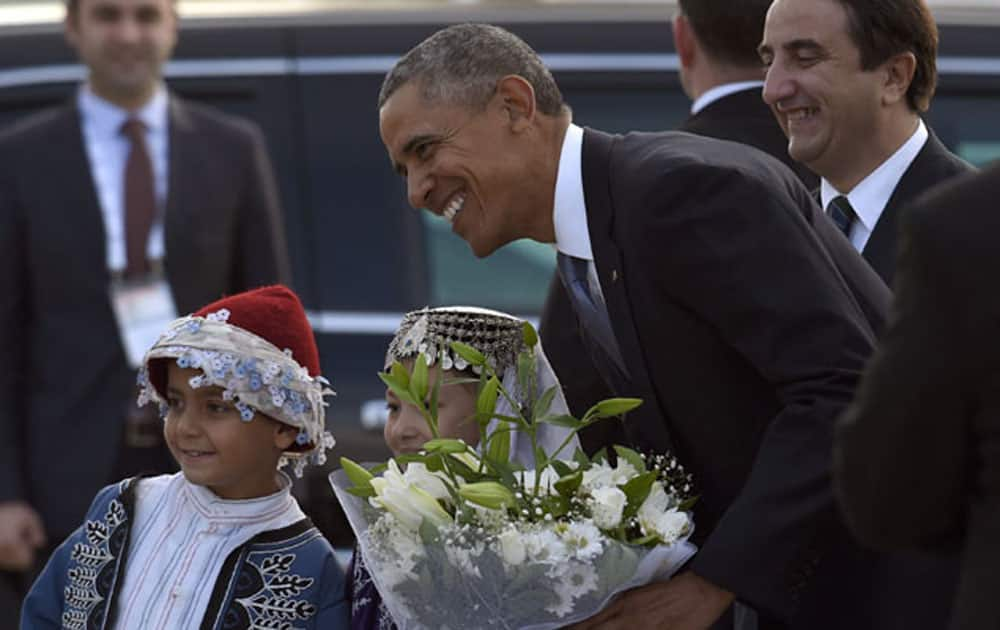 US President Barack Obama is greeted by children as he arrives via Air Force One at Antalya International Airport in Antalya.