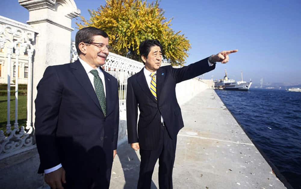 Japan’s Prime Minister Shinzo Abe, right, and his Turkish counterpart Ahmet Davutoglu speak as they stand on the Bosporus in Istanbul, Turkey.