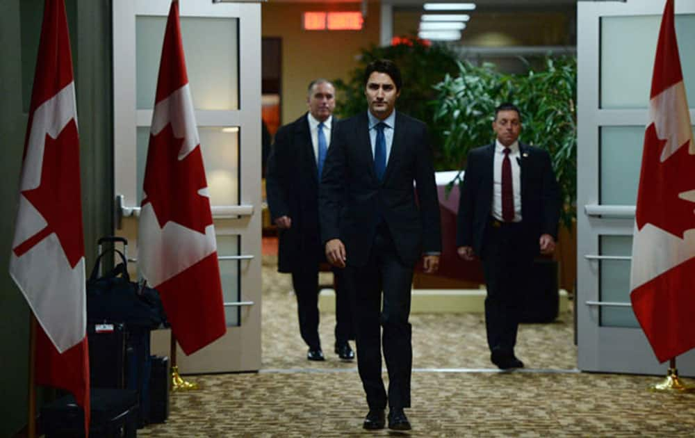 Canadian Prime Minister Justin Trudeau arrives to address the media on the terrorist attacks in Paris prior to his departure for the G20 and APEC summits from Ottawa.