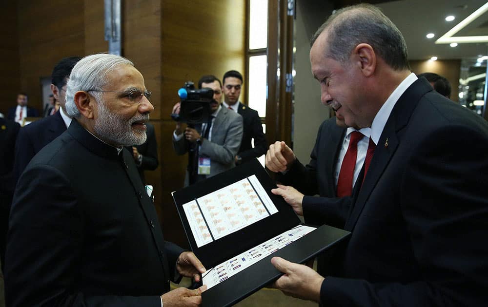 Turkish President Recep Tayyip Erdogan, right, presents a photo album to Indian Prime Minister Narendra Modi at the end of the G-20 Summit in Antalya, Turkey.