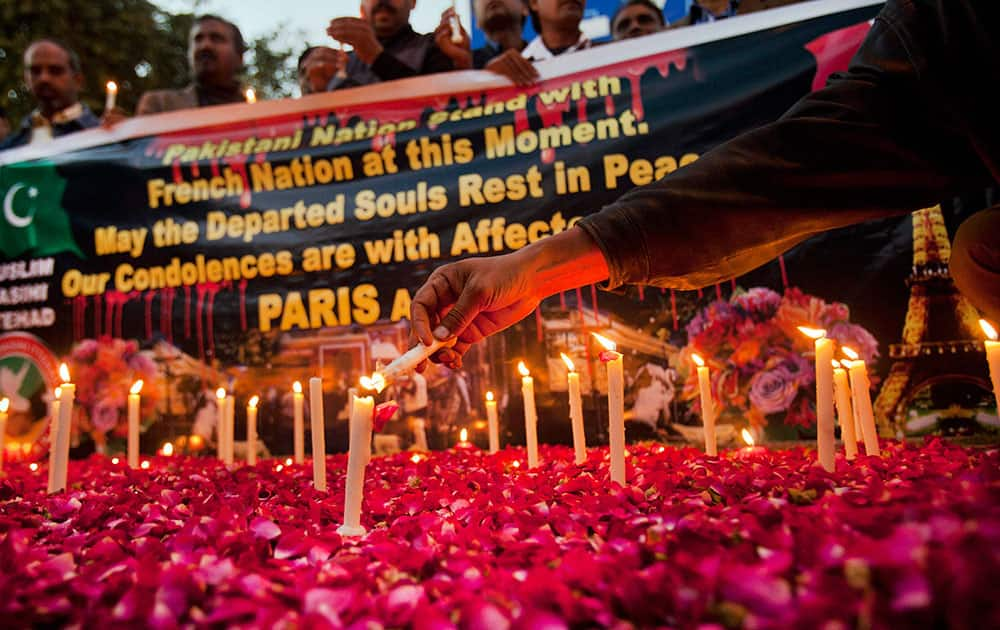 Pakistani Christians light candles for victims who were killed in Fridays attacks in Paris during a vigil in Islamabad, Pakistan.