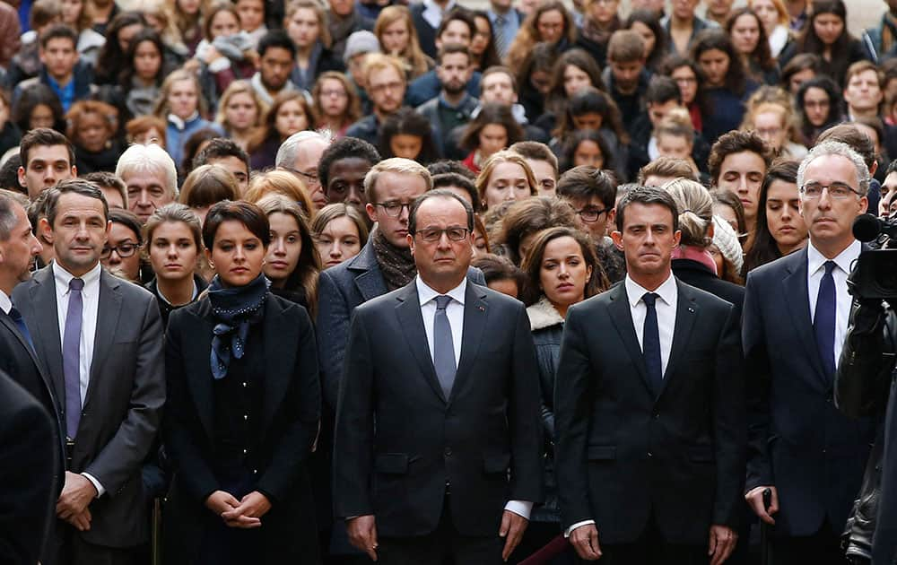 French President Francois Hollande,  French Prime Minister Manuel Valls and French Education Minister Najat Vallaud-Belkacem stand among students during a minute of silence.