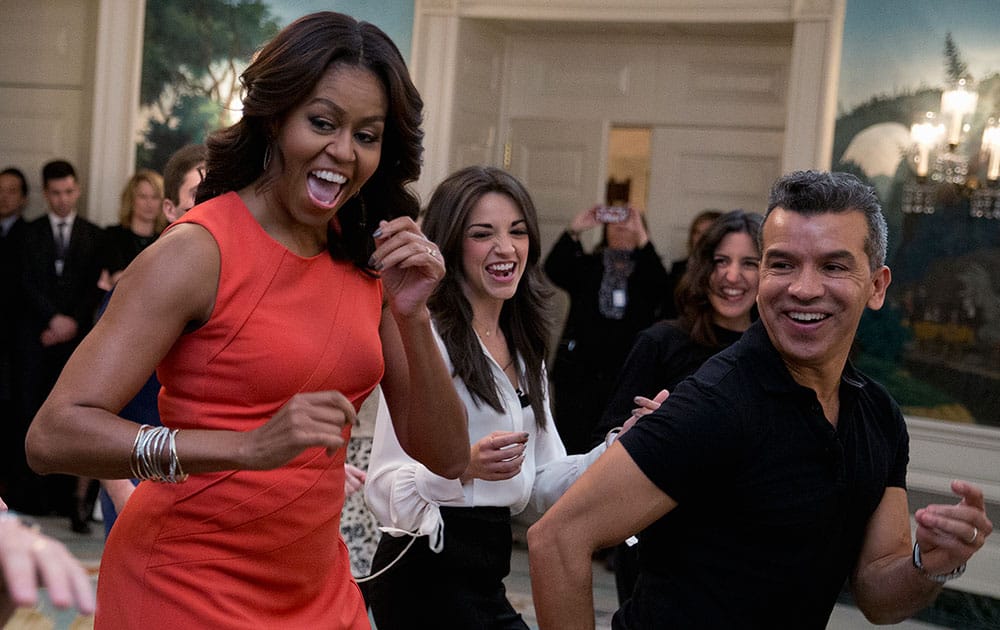 First lady Michelle Obama dances to Gloria Estefan's 'Conga' in the Diplomatic Room of the White House in Washington.