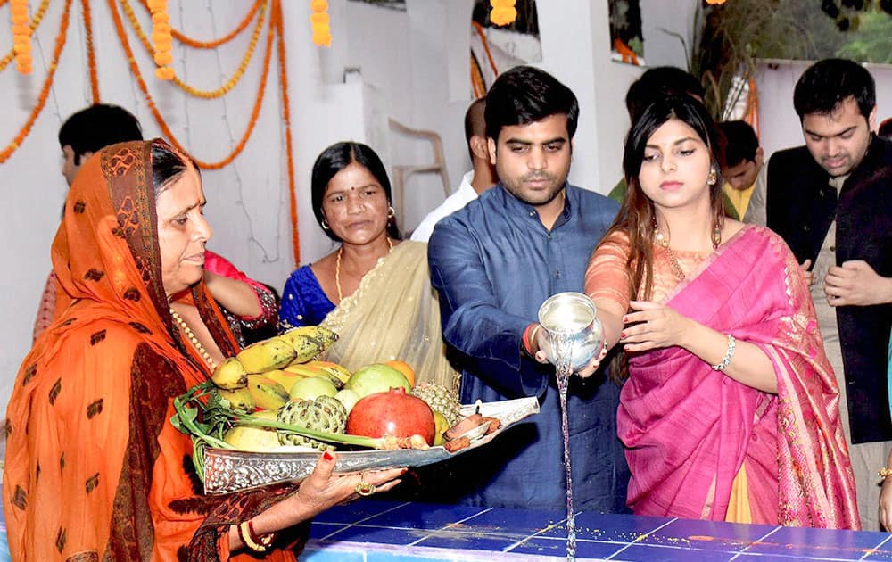 RJD leader Rabri Devi performs rituals with her daughter and son-in-law Tej Pratap, Samajawadi Party MP during Chhath Puja in Patna.