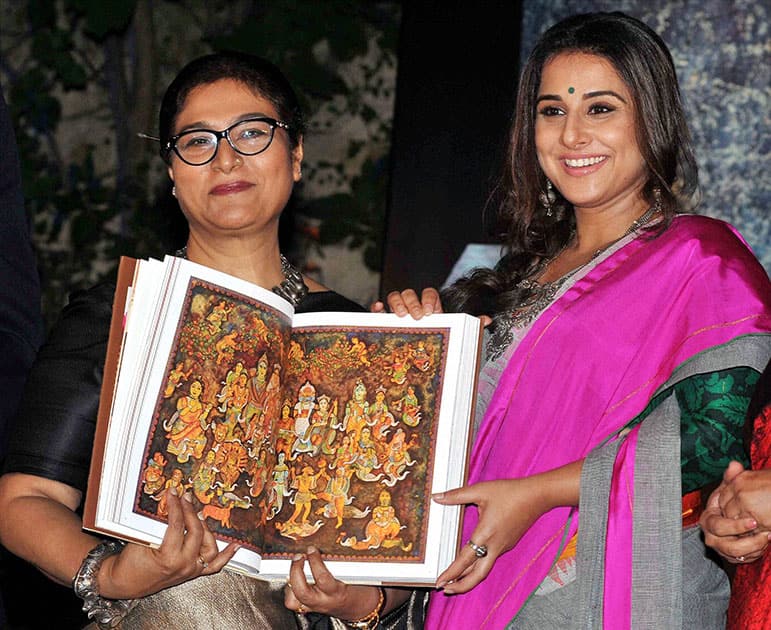 Bollywood actress Vidya Balan releasing a coffee table book Antaryatra of noted painter & sculpturer Jayashri Burman(L) during the inauguration of her painting and sculpture exhibition, in Kolkata.