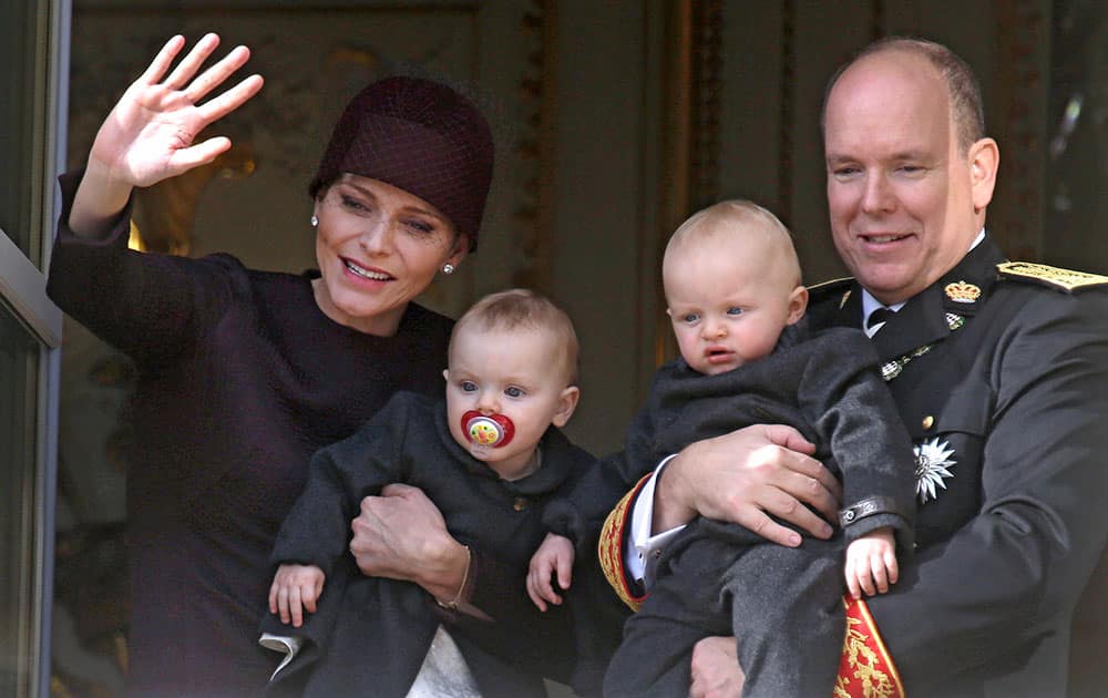 Prince Albert II of Monaco with his wife Princess Charlene and their twins, Prince Jacques, right, and Princess Gabriella, wave from Monaco palace during Monaco's national day ceremony.