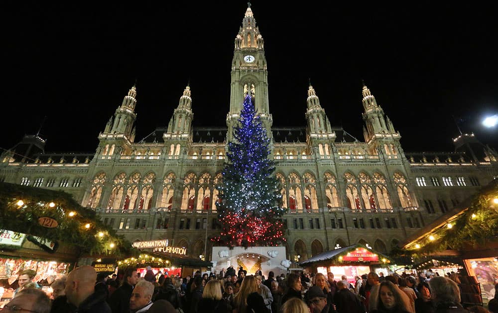 Vienna's Christmas tree is lit in the colors of the French flag to show solidarity with the victims of last week's attacks in Paris, at the Christmas market in front of the neo-Gothic City hall in Vienna, Austria.