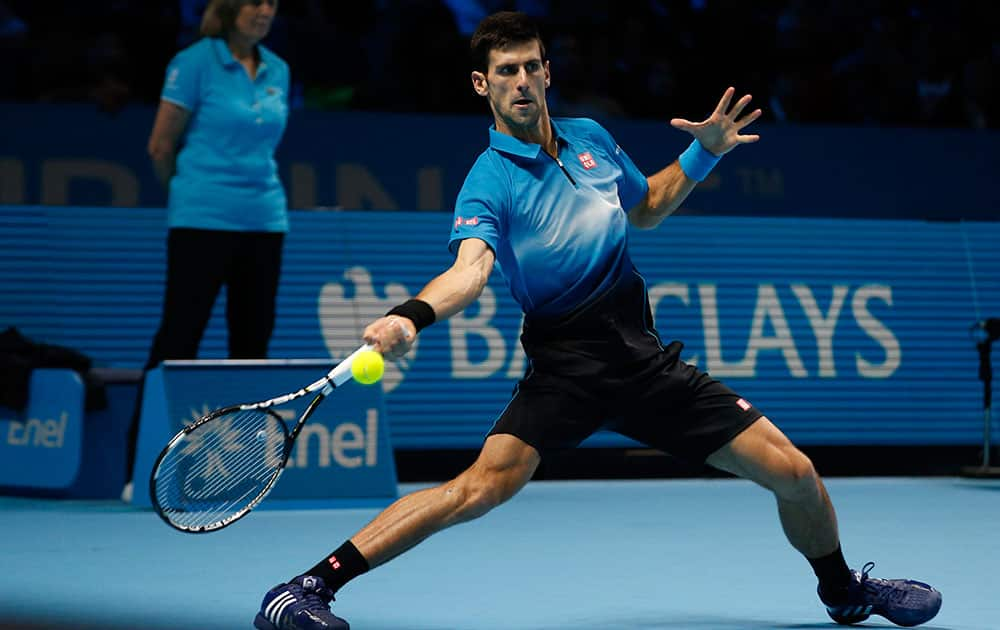 Novak Djokovic of Serbia plays a return to Tomas Berdych of the Czech Republic during their singles tennis match at the ATP World Tour Finals at the O2 Arena in London.