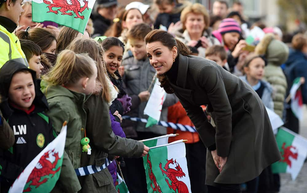 Kate, the Duchess of Cambridge meets members of the public as she arrives in Castle Square, Caernarfon, North Wales. Britain's Prince William and the Duchess of Cambridge are on a visit to North Wales to highlight charity work for young people's mental health. 