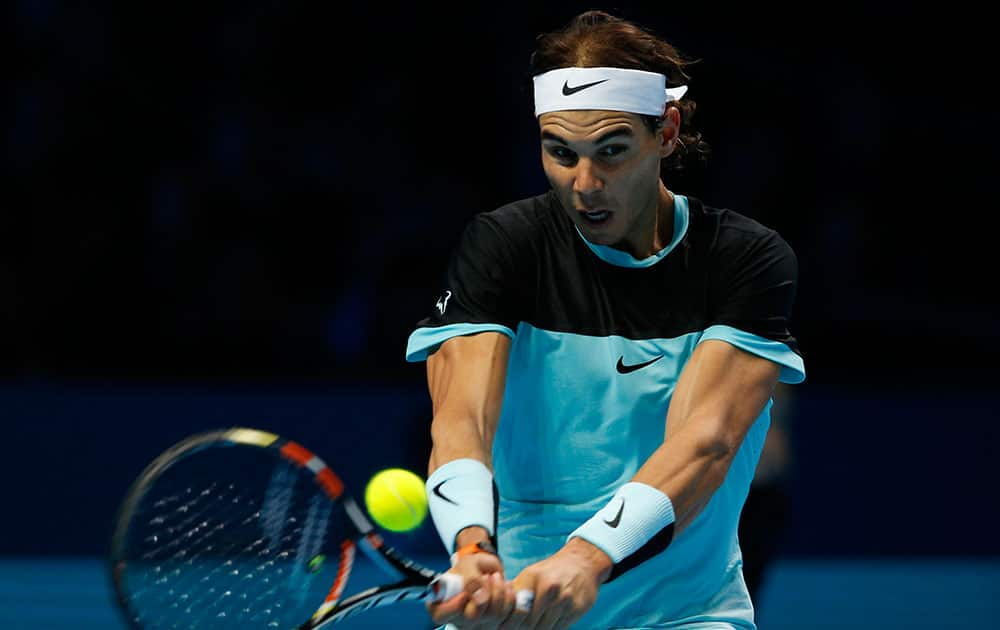 Rafael Nadal of Spain huts a return to David Ferrer of Spain during their singles tennis match at the ATP World Tour Finals at the O2 Arena in London.