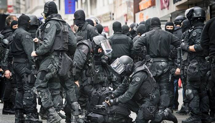 Belgium weighs extending lockdown, police hunt Paris attackers