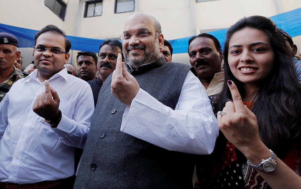 BJP President Amit Shah shows her inked finger after casting vote in Ahmedabad Municipal Corporation election at Naranpura, Ahemdabad.