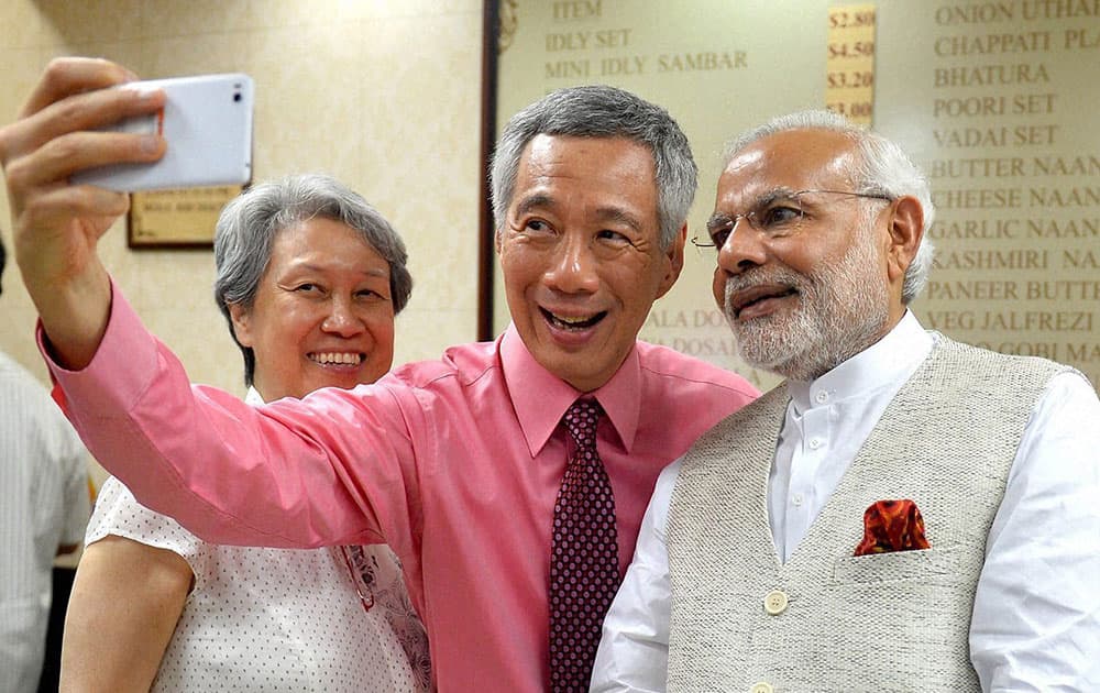Singaporean Prime Minister Lee Hsien Loong poses with Prime Minister Narendra Modi for a selfie , at Komala Vilas Restaurant, Little India, Singapore.