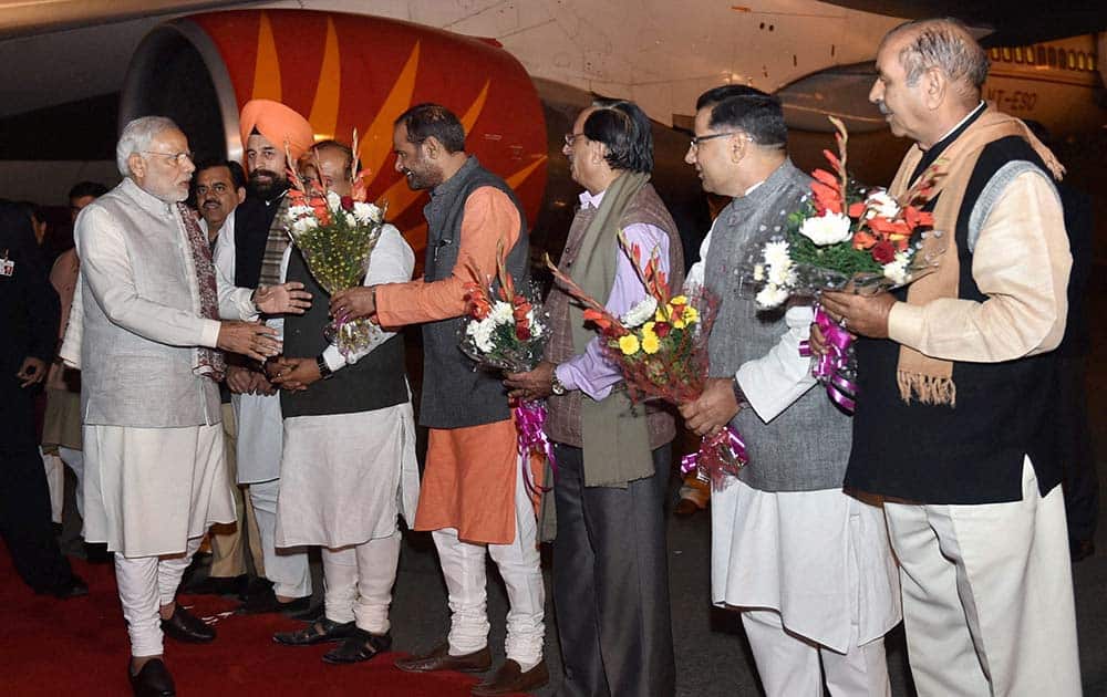 Prime Minister Narendra Modi being welcomed by the party leaders and workers on his arrival from Singapore at Palam Airport in New Delhi during the wee hours.