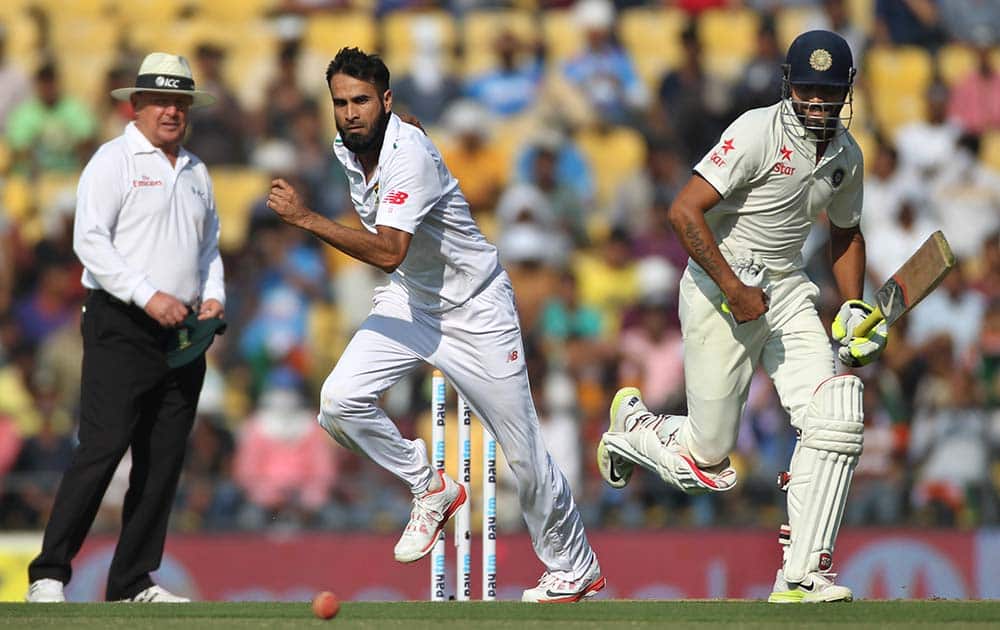 Ravindra Jadeja, right, takes off for a run as South African bowler Imran Tahir tries to field, on the first day of the third test match between the two countries in Nagpur.