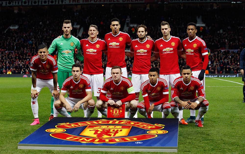 Manchester United's players pose for the photographers before the Champions League group B soccer match between Manchester United and PSV Eindhoven at Old Trafford Stadium in Manchester, England.