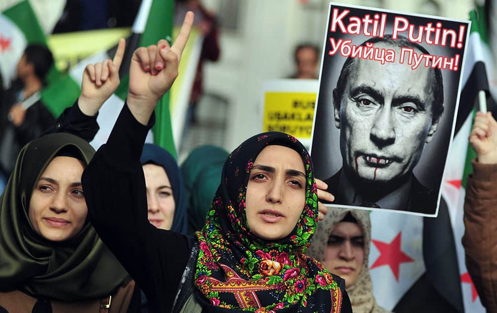 Turkish protesters shout anti-Russia slogans as they hold a poster of Russian President Vladimir Putin that reads in Turkish and Russian Assassin Putin! during a protest in Istanbul.