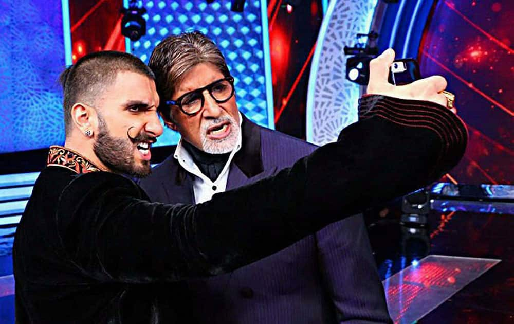 Bollywood actor Ranveer Singh takes selfie with Amitabh Bachhan during a television show in Mumbai.