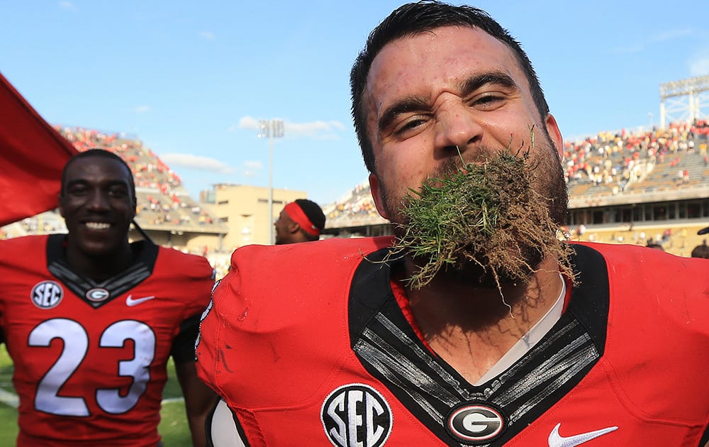 Georgia linebacker Ryne Rankin celebrates with a mouthful of turf after their 13-7 victory over Georgia Tech in an NCAA college football game.