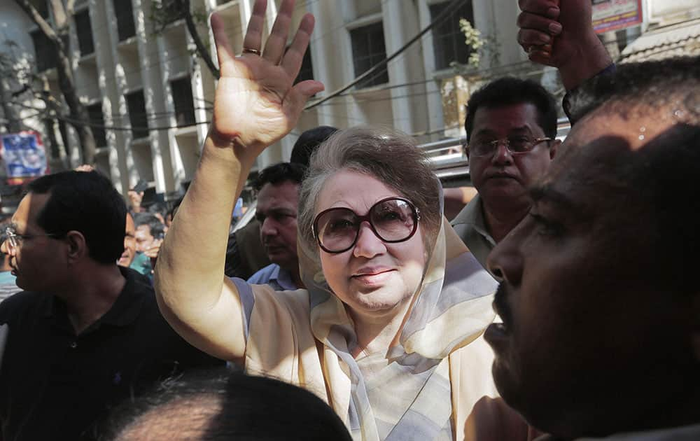 Former Bangladeshi Prime Minister Khaleda Zia waves as she arrives for a court appearance in connection with a corruption case in Dhaka, Bangladesh.