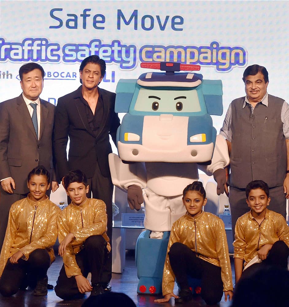 Transport Minister Nitin Gadkari with Bollywood actor and Hyundai brand ambassador Shahrukh Khan and Managing Director, Hyundai Motor India Ltd., Y K Koo pose with Mascot of the Hyundai India Safe Move campaign, Robocar Poli during the launch of the traffic safety campaign, in New Delhi.