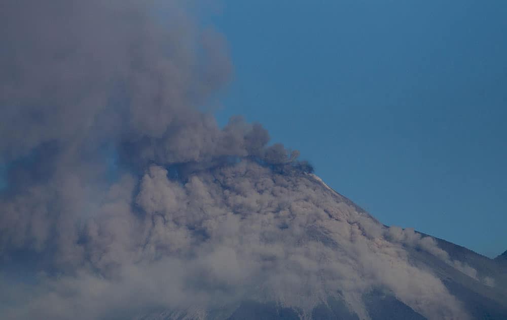 Volcan de Fuego or Volcano of Fire blows outs a thick cloud of ash as seen from Escuintla, Guatemala. 