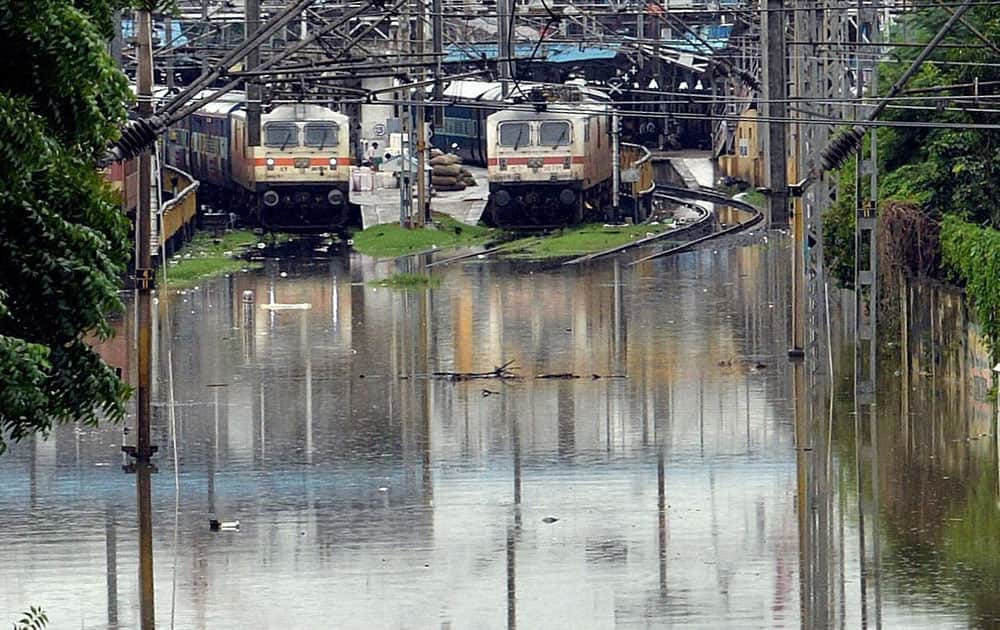 Trains stand stranded at a railway station near flooded tracks after heavy rains in Chennai.