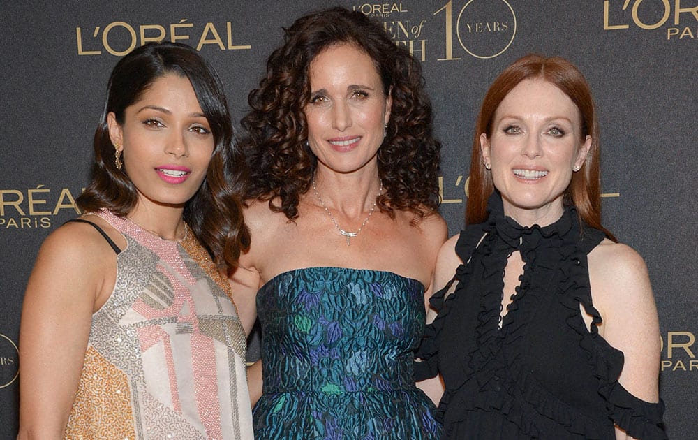 LOreal brand ambassadors, from left, Freida Pinto, Andie MacDowell and Julianne Moore pose together at the tenth annual LOreal Paris Women of Worth awards gala at The Pierre Hotel in New York. 
