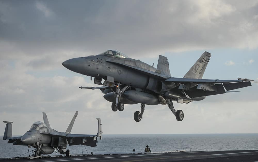 A F/A-18 Hornet lands aboard the nuclear-powered aircraft carrier USS Harry S. Truman, during a visit by Ukraine's Prime Minister Arseniy Yatsenyuk, at an undisclosed position in the Mediterranean Sea, south of Sicily.